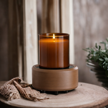 Load image into Gallery viewer, 2-in-1 wax warmer in pewter walnut finish warming an amber glass jar candle on neutral wood surface