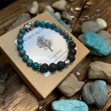 Load image into Gallery viewer, American turquoise essential oil bracelet with elephant charm sitting on gift box