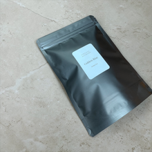 Load image into Gallery viewer, Packaged loose-leaf herbal tea in a kraft pouch with a minimalist label.