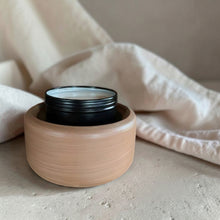Load image into Gallery viewer, Matte black Apothecary Dish on wood 2-in-1 wax warmer with snapped wax melt pieces in a soft botanical studio setting