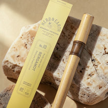Load image into Gallery viewer, Bergamot bamboo incense sticks by Herb & Earth with wooden incense holder on natural stone