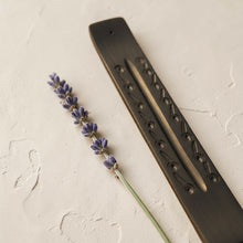 Load image into Gallery viewer, black carved wooden incense burner with lavender on neutral limewashed plaster surface