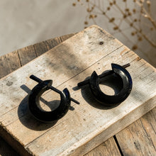 Load image into Gallery viewer, black tribal wood hoop earrings with stick post on rustic wood board boho artisan wooden jewelry