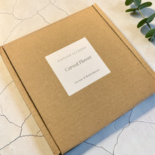 Load image into Gallery viewer, Vintage Alchemy carved flower stone incense and resin burner packaging box on cracked mineral plaster surface with eucalyptus branch