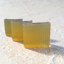 Load image into Gallery viewer, Three bars of Cognac glycerin soap arranged on a light stone surface in natural daylight