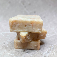 Load image into Gallery viewer, stack of handmade gardeners grit exfoliating cold process soap bars with calendula on natural stone background
