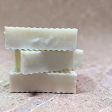 Load image into Gallery viewer, stacked shea butter glycerin soap bars aura soft floral musk with smooth translucent finish on neutral limestone background