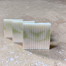 Load image into Gallery viewer, shea butter glycerin soap bars aura soft floral musk with subtle green swirl on neutral stone background