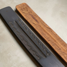 Load image into Gallery viewer, hand carved wooden incense burners in black and natural wood on neutral plaster background