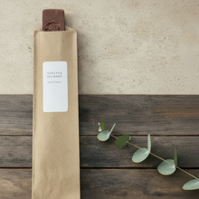 Load image into Gallery viewer, Wood incense burner packaged in kraft sleeve with Vintage Alchemy label on weathered wood background with soft botanical accents.