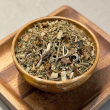 Load image into Gallery viewer, loose leaf lemon ginger rooibos herbal tea blend in ceramic bowl on wood tray