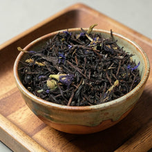 Load image into Gallery viewer, loose leaf black tea with botanicals in ceramic bowl on wood tray