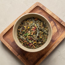 Load image into Gallery viewer, Loose leaf peach apricot white tea blend with fruit and botanicals in ceramic bowl on wooden tray