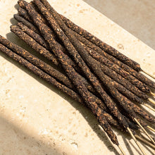 Load image into Gallery viewer, Temple Rose herb and resin incense sticks on natural stone surface with visible rose and resin botanicals
