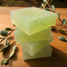 Load image into Gallery viewer, Stack of green soap bars on a wooden surface with olive leaves.