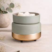 Load image into Gallery viewer, 2-in-1 wax warmer in sage green and brushed gold finish with white wax melts on neutral studio background
