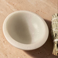 Load image into Gallery viewer, White marble smudge bowl for incense and resin burning on warm mineral surface with bundled sage