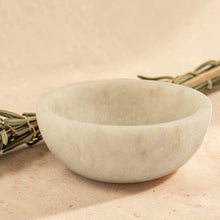 Load image into Gallery viewer, White marble smudge bowl for incense and resin burning on neutral stone surface with dried botanical stem
