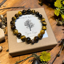 Load image into Gallery viewer, yellow tiger eye stretch bracelet sitting on gift box