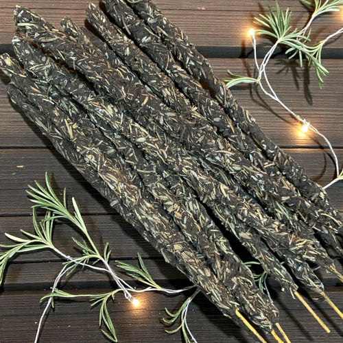 Dried lavender and rosemary sticks on a wooden surface with string lights