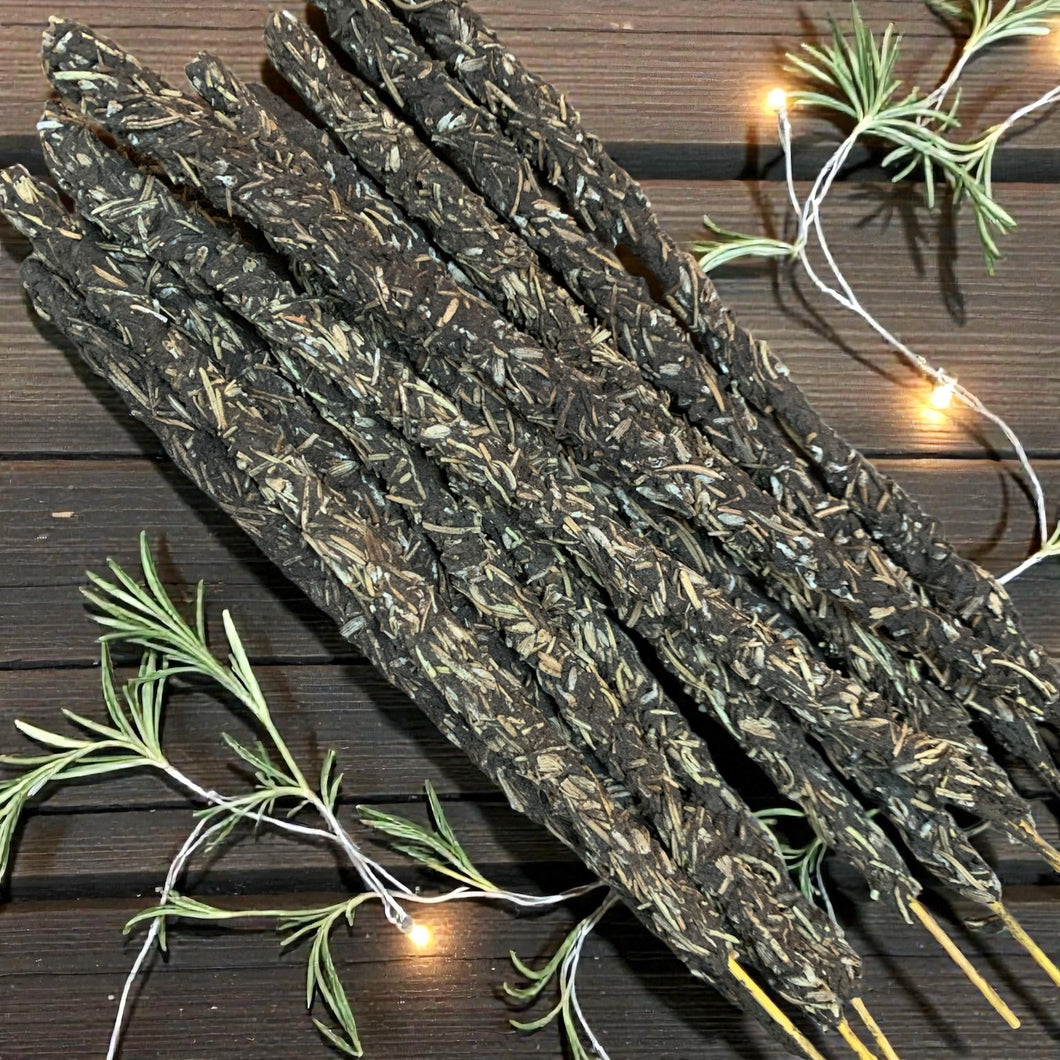 Dried lavender and rosemary sticks on a wooden surface with string lights