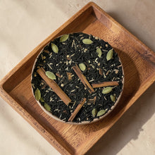 Load image into Gallery viewer, spiced chai black and green tea in a rustic bowl on a wooden tray
