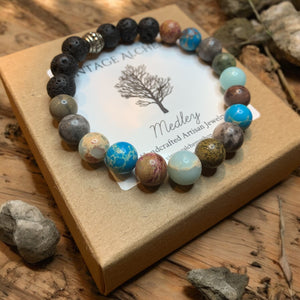 Mixed stone beaded bracelet for essential oils sitting on gift box