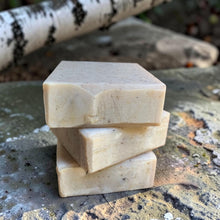 Load image into Gallery viewer, Three bars of Birchwood cold process soap displayed on weathered stone with a soft-focus birch branch in the background
