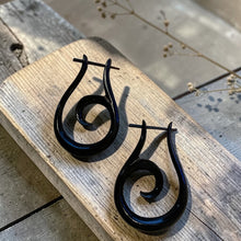 Load image into Gallery viewer, black spiral tribal wood earrings with stick post on rustic wood board boho artisan wooden jewelry

