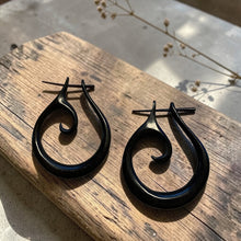Load image into Gallery viewer, black spiral wood earrings with stick post on rustic wood board boho tribal artisan wooden jewelry
