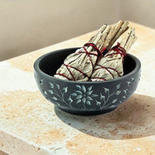 Load image into Gallery viewer, Black carved stone smudge bowl holding sage bundles for cleansing and incense use

