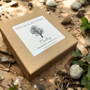 box for stretch bracelet sitting on a rock surface