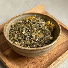 Load image into Gallery viewer, Loose leaf dandelion root and leaf herbal tea in ceramic bowl on wooden tray
