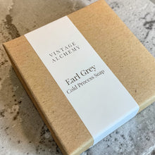 Load image into Gallery viewer, Vintage Alchemy Earl Grey cold process soap in kraft box with minimal white label on natural stone background
