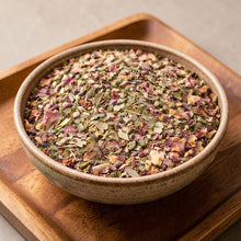 Load image into Gallery viewer, loose leaf eucalyptus mint herbal tea blend with rose petals in ceramic bowl on wood tray
