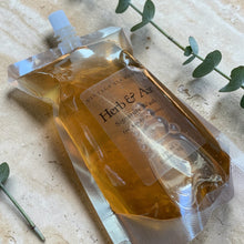 Load image into Gallery viewer, Vintage Alchemy Herb &amp; Air Signature Wash liquid soap refill pouch on natural stone surface with eucalyptus botanical styling
