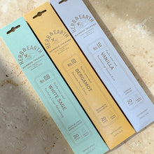 Load image into Gallery viewer, Herb &amp; Earth bamboo incense sticks in White Sage, Bergamot, and Vanilla on warm stone surface
