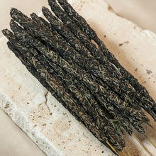 Load image into Gallery viewer, Herbal Drift botanical incense sticks with dried herb coating on pale mineral stone surface
