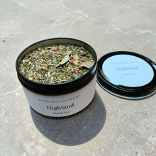 Load image into Gallery viewer, Herbal tea container labeled 'Highland' from 'Vintage Alchemy' on a concrete surface.
