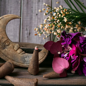 incense cones with a moon in the background