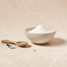 Load image into Gallery viewer, White kaolin clay powder in ceramic bowl with wooden spoon on soft neutral stone surface for Vintage Alchemy clay mask product imagery
