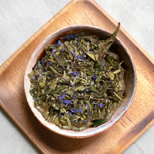 Load image into Gallery viewer, Loose leaf lavender blueberry herbal tea with cornflower petals in ceramic bowl on wooden tray
