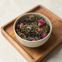 Load image into Gallery viewer, Loose leaf lavender silk white tea with clover blossoms and botanicals in ceramic bowl on wooden tray
