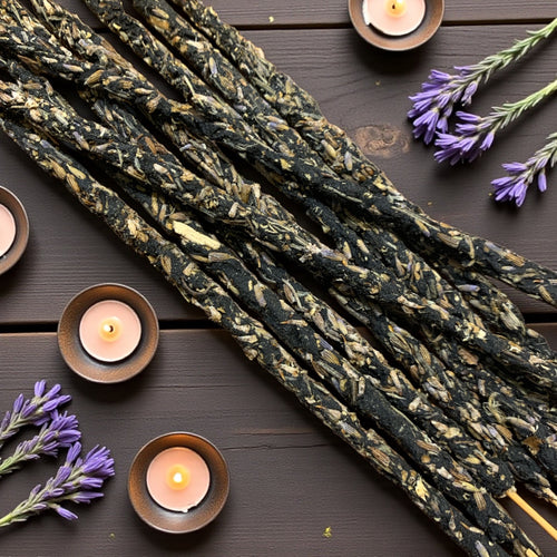 lavender incense on a wooden surface with candles and lavender flowers.