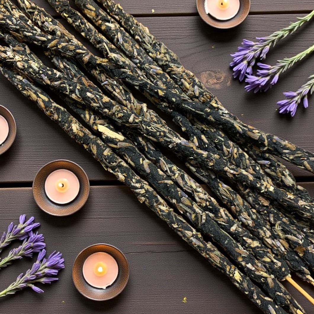 lavender incense on a wooden surface with candles and lavender flowers.