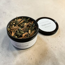 Load image into Gallery viewer, Open tin of Maplewood loose-leaf black and green tea blend featuring cinnamon bark, cardamom, and tea leaves displayed on a neutral stone surface.
