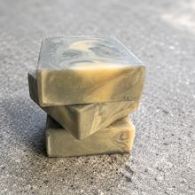 Load image into Gallery viewer, Stacked bars of Marlowe cold process soap showing handcrafted charcoal and cream marbling on a neutral stone background.
