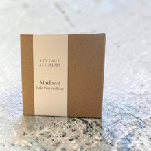 Load image into Gallery viewer, Vintage Alchemy Marlowe cold process soap in a kraft paper box with a minimalist label displayed on a textured stone surface.
