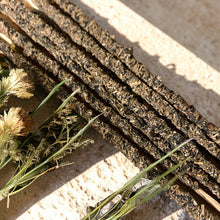 Load image into Gallery viewer, Mother Nature herb and resin incense sticks with dried botanicals on pale stone surface
