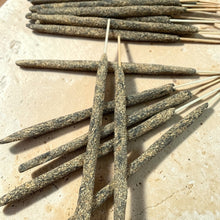 Load image into Gallery viewer, Palo Santo herb and resin incense sticks arranged on pale natural stone surface
